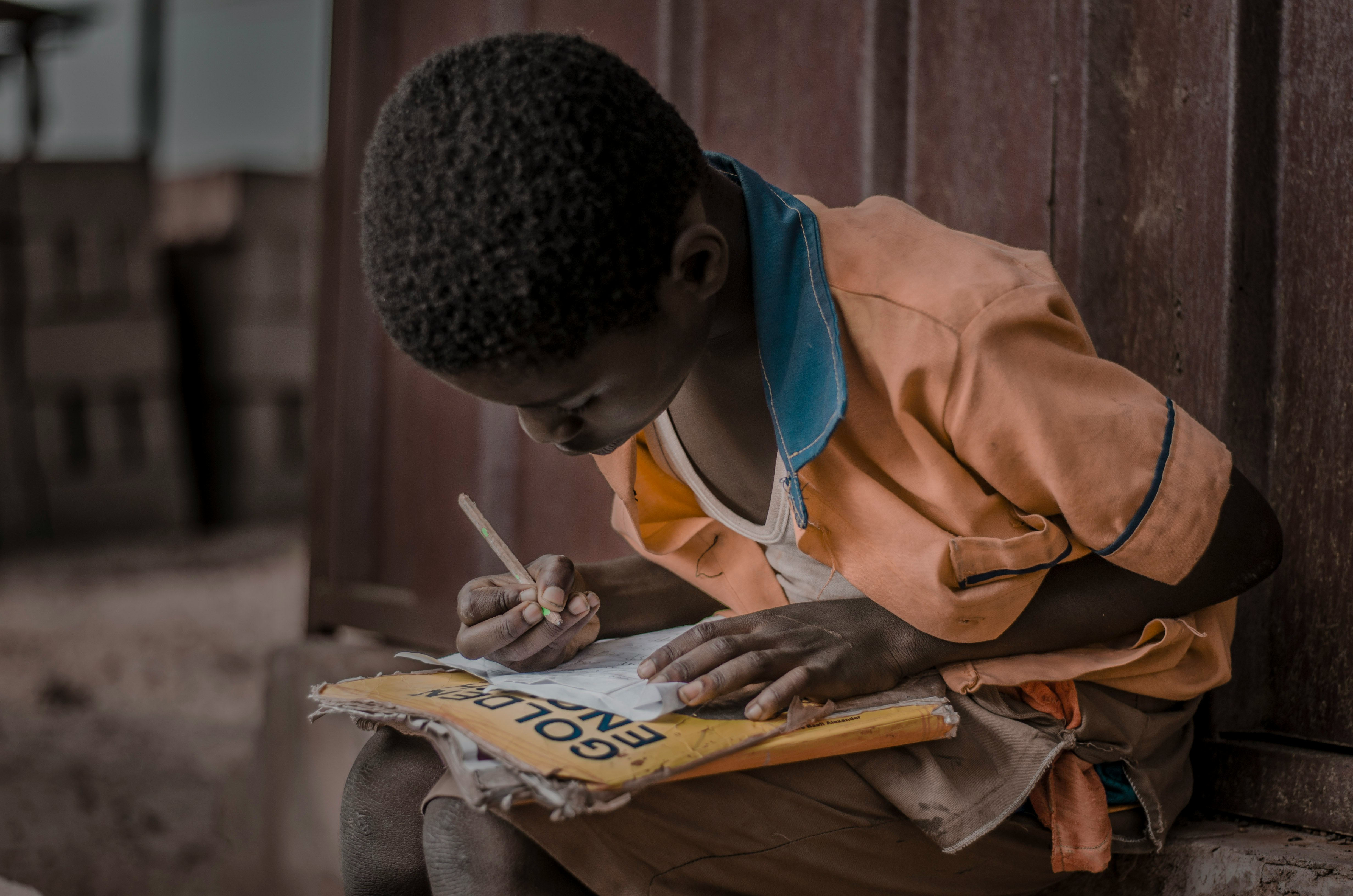 man in brown jacket reading newspaper